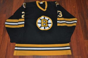 Vintage Boston Bruins. #23 Charlie Simmer. Knit CCM. Jersey shows good repairs. Autograph on lower hem. Coming soon.